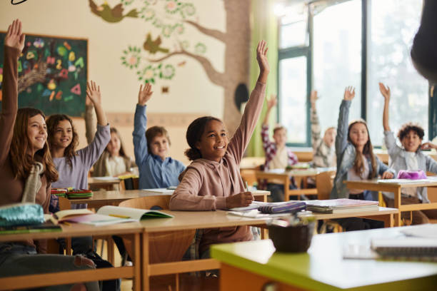 Child raising hand in classroom