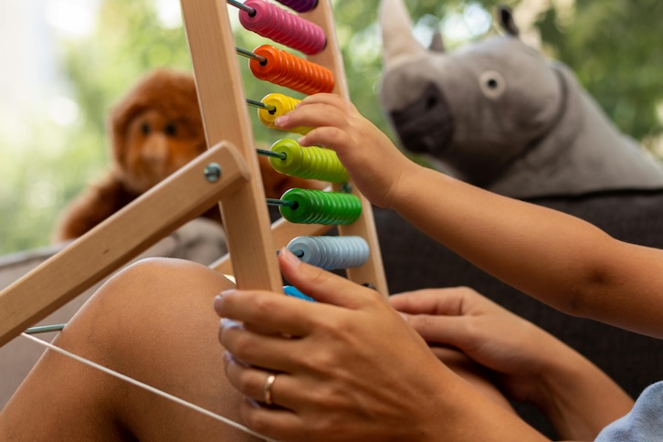 Child playing with an abacus