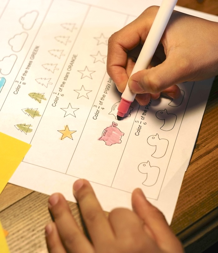 Child completing a printed worksheet
